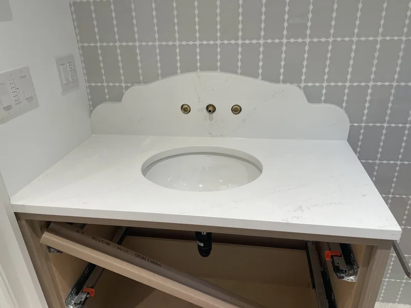 Vanity surface with a shaped backsplash