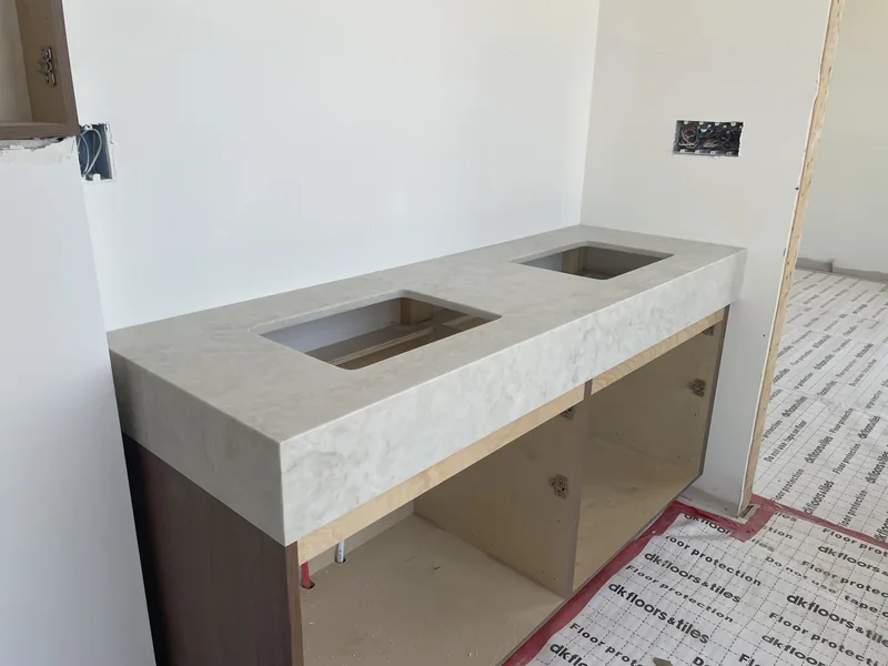 Double-basin cutouts in a thick-front vanity