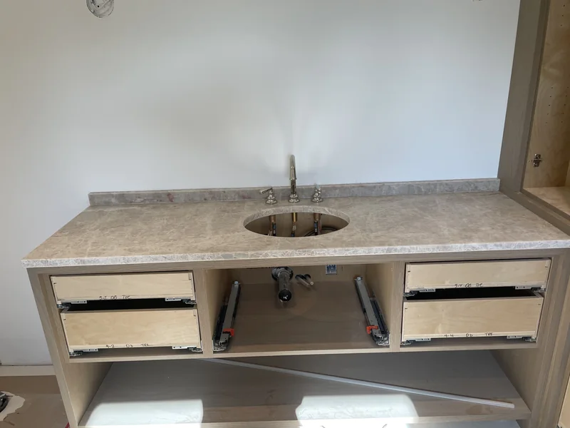 Pale patterned vanity with an oval basin opening