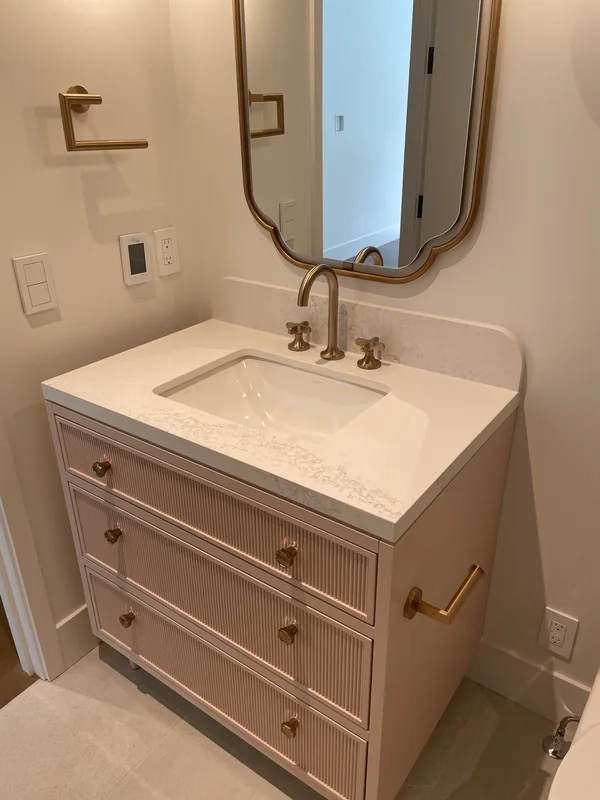 Blush-toned vanity with brass-toned fittings