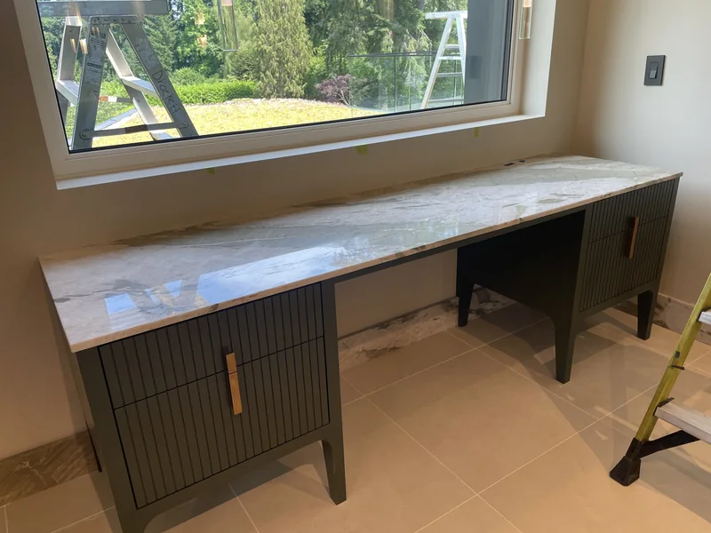 Patterned dressing-room counter with dark green cabinets