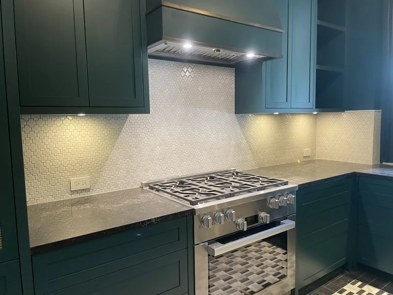 Cooking-area countertop beside a tiled backsplash