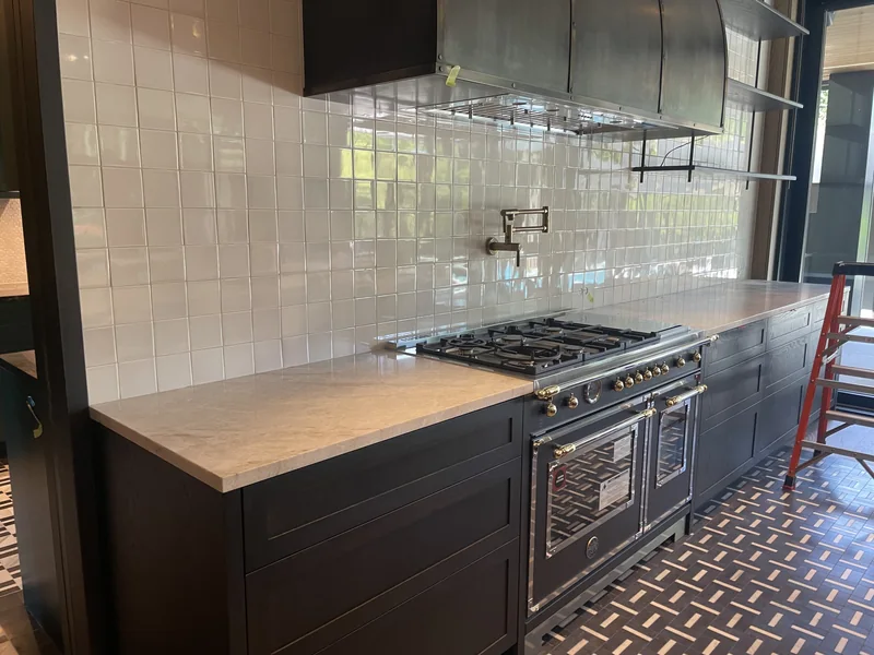 Light cooking-area counter with dark cabinetry