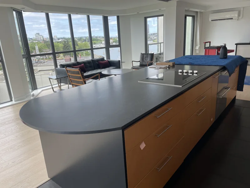 Dark kitchen island with a rounded seating end