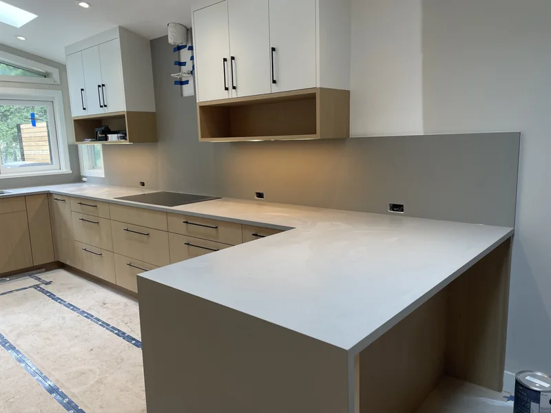 Light peninsula countertop with a waterfall return
