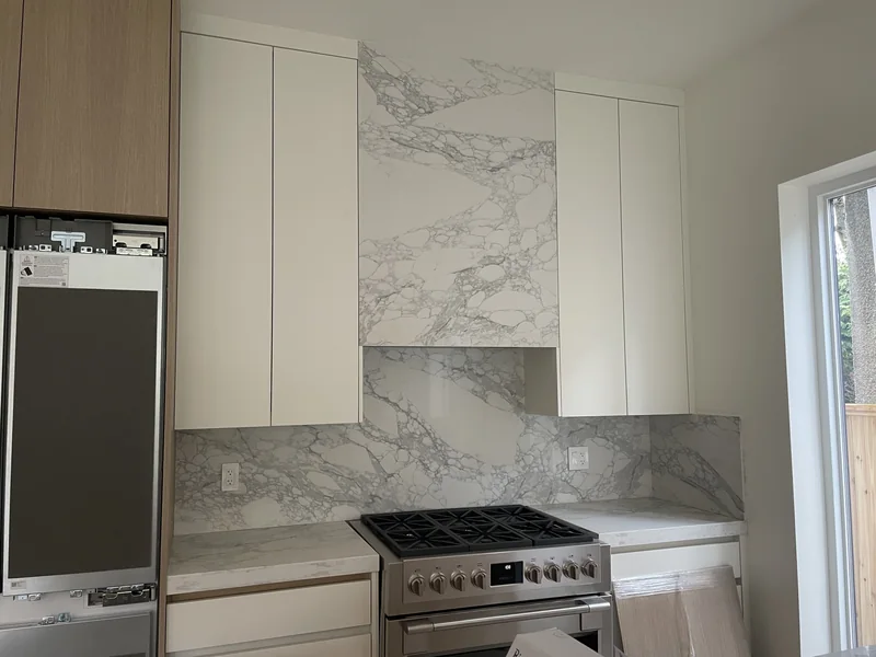 Tall patterned hood surround above the cooking area