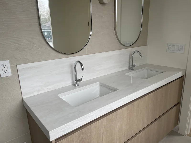 Linear-patterned double vanity with wood cabinetry