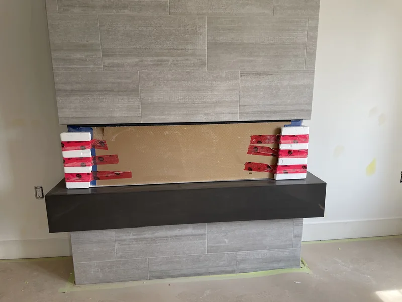 Deep-toned hearth ledge during fireplace installation