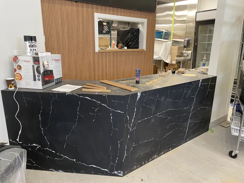 Dark veined service counter during fit-out