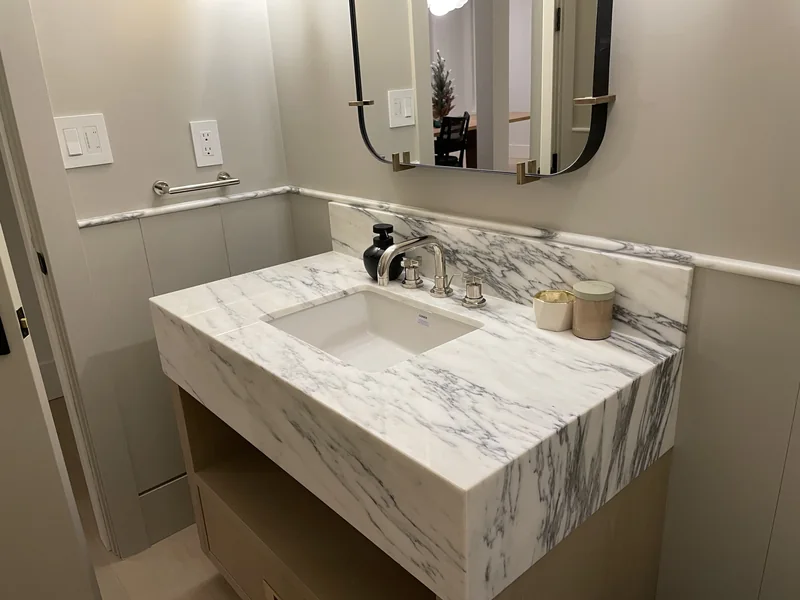 Bold veined vanity with a deep apron and chrome fittings