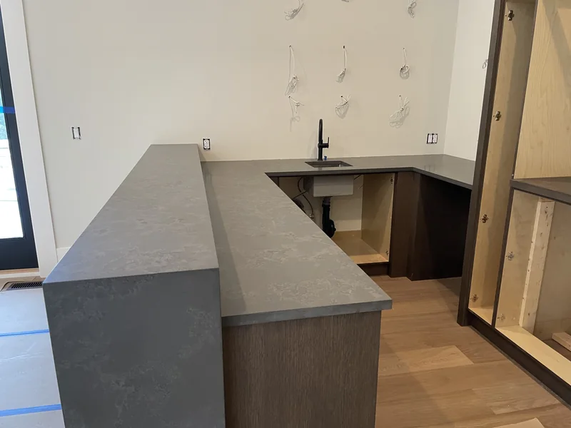 Two-level wet-bar countertop with a waterfall side